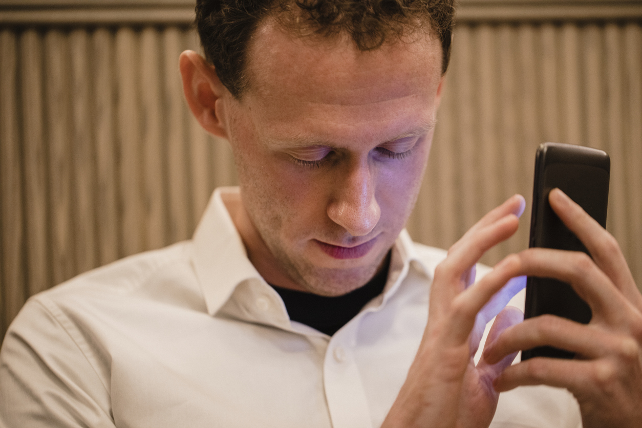 Visually impaired men holding a mobile device