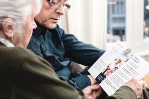 Elderly couple looking at PHSO How to complain leaflet
