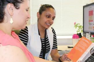 PHSO staff looking at leaflet