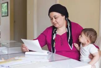 Woman and baby looking at documentation