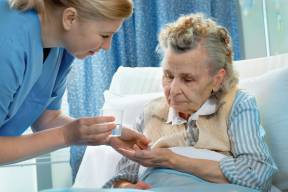 Elderly woman in hospital with nurse