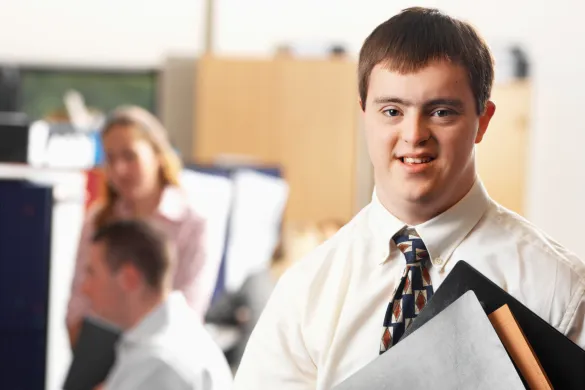 Young man with downs syndrome looking at the camera